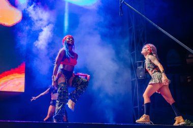 Kemer, Turkey - September 21, 2025 - Raza Urbana dancers perform a powerful stage routine with dramatic lighting and smoke. A woman in red leads with intensity and energy during a live show.