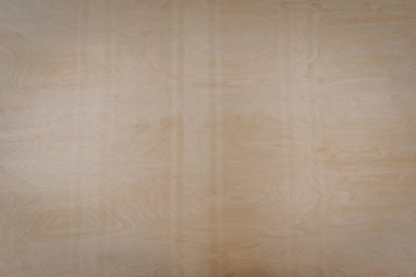 Açık renkli ahşap bir yüzeye yakın çekim, doğal tahıl ve düğümler, arka plan veya malzeme kullanımı için ahşaptaki dokuyu ve ince desenleri gösterir.