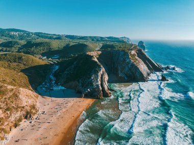 Panoramic aerial view for idyllic sandy Praia da Adraga (Adraga Beach). Portugal, Europe clipart