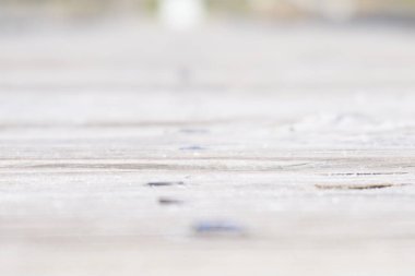close up of a white wooden walk way with a blurred background