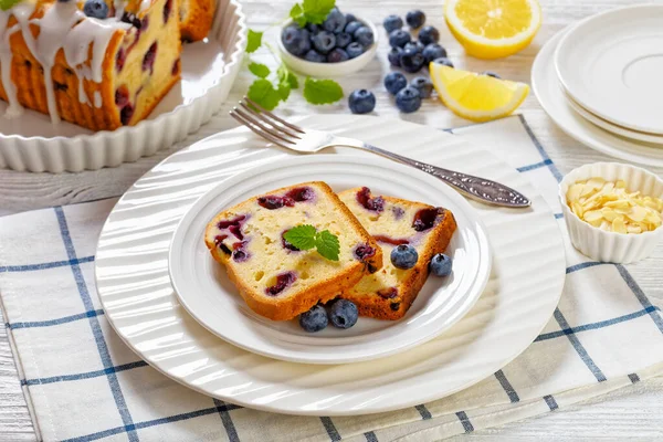 Slices Lemon Blueberry Bread Lemon Glaze Plate White Wood Table — Stock Photo, Image