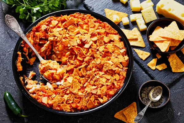 Tortilla Chips Chicken Cheese Casserole Baking Dish Spoon Concrete Table — Stock Photo, Image