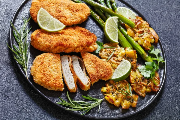 Close Fried Breaded Chicken Breasts Roast Asparagus Smashed Potatoes Lime — Stock Photo, Image
