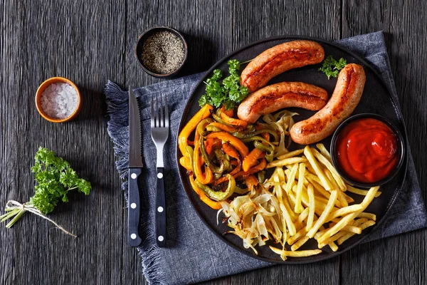 Grilled Sausages Sliced Green Orange Peppers Onion French Fries Black — Stock Photo, Image