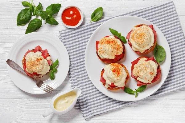 Eggs Benedict English Muffin Soft Cheese Ham Tomato Basil Leaves — Stock Photo, Image