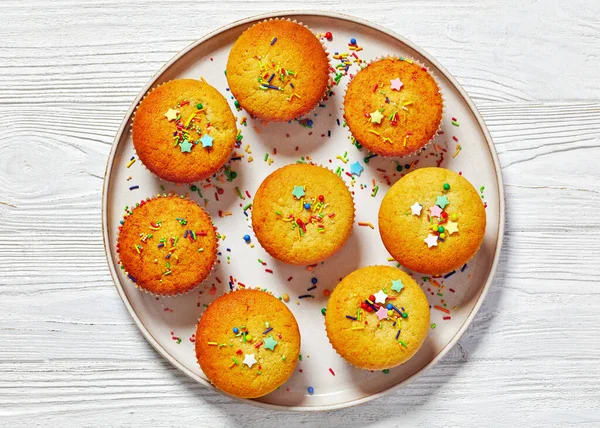 Sweet Lemon Muffins Topped Holiday Sprinkles Plate White Wooden Table — Stock Photo, Image