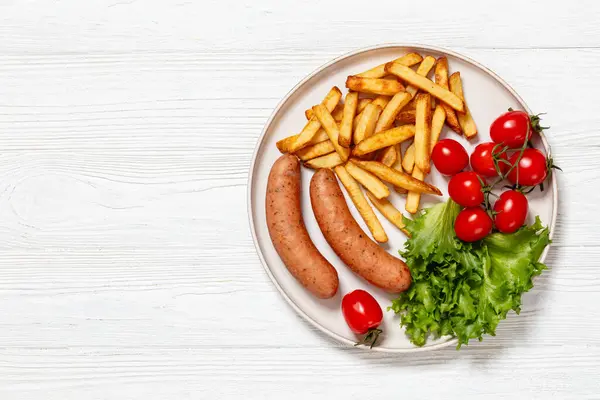 Italian Sausages French Fries Lettuce Fresh Tomatoes Plate White Wooden — Stock Photo, Image