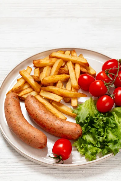 Italian Sausages French Fries Lettuce Fresh Tomatoes Plate White Wooden — Stock Photo, Image