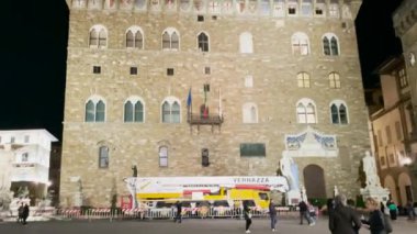 Bir kamera hızla dönüyor, Palazzo Vecchio 'nun etkileyici yüzünü ve saatini gösteriyor.