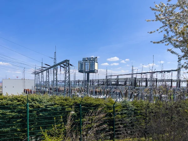 Electric power transmission substation during clear summer day sky