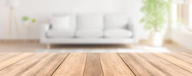 Blur modern living room with sofa and wooden table top vintage home style for house products montage advertising background