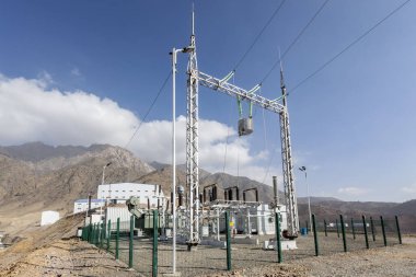 View of the electrical substation (electrical switchyard) for industrial mining plant on the mountain. A substation is a part of an electrical generation, transmission, and distribution system.