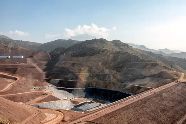 View of the industrial mine waste dam (tailing dam). A tailings dam is typically an earth-fill embankment dam used to store byproducts of mining operations after separating the ore from the gangue.