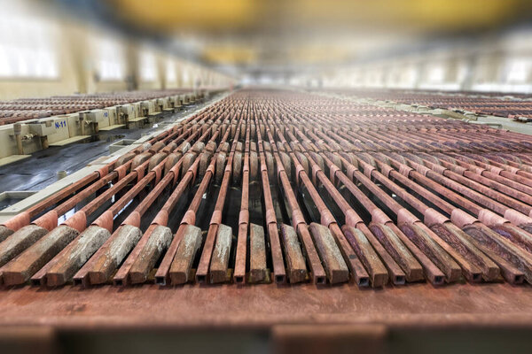 Медные электролизо-катодные пластины. Медь очищается электролизом. Отлитые из обработанной меди аноды помещаются в водный раствор (медный сульфат и серная кислота).).