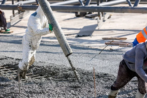 Pouring out concrete with ready-mix concrete (RMC) in the construction site. Ready mix concrete is a batch of concrete that is mixed before being delivered.