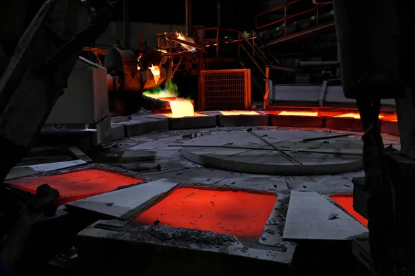 View of the copper casting to the molds in the smelting of the industrial plant. Smelting is a process of applying heat to ore in order to extract a base metal.