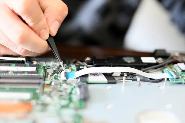 Expert is repairing to inner of laptop with screwdriver. The design restrictions on power, size, and cooling of laptops limit the maximum performance of laptop parts compared.