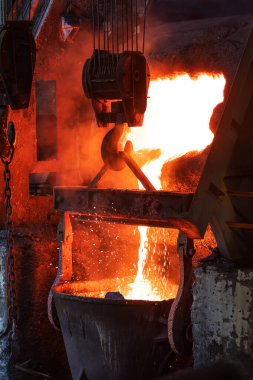 Molten copper is pouring to melting pot. Combining copper with tin and/or arsenic in the right proportions produces bronze, an alloy that is significantly harder than copper.