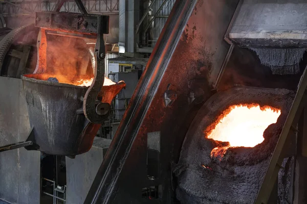 Molten copper is pouring to melting pot. Combining copper with tin and/or arsenic in the right proportions produces bronze, an alloy that is significantly harder than copper.
