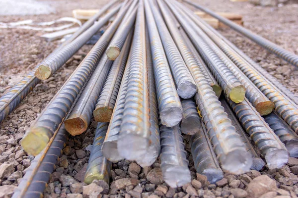 Rebars. It is a steel bar or mesh of steel wires used as a tension device in reinforced concrete and reinforced masonry structures to strengthen. Steel bars on construction site.
