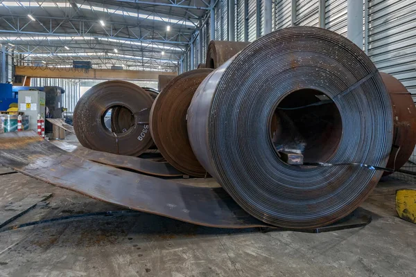 View of the hot rolled carbon steel plate coils to make spiral welded pipe (strips, rolls, sheets) in the metal factory.