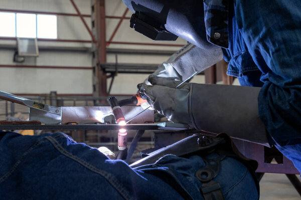 View of the double tig or gtaw (Gas tungsten, inert arc welding) welding techniques. Synchronized welding without direct eye contact requires a lot of experience.