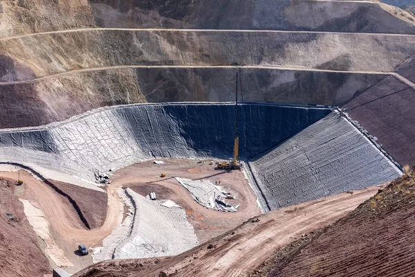 View of the industrial mine waste dam (tailing dam). A tailings dam is typically an earth-fill embankment dam used to store byproducts of mining operations after separating the ore from the gangue.