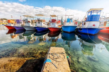 View of the different colored of the fishing boats in Black Sea area, Trabzon, Turkey.