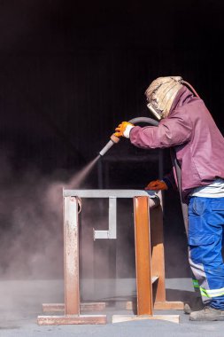 Sandblasting or abrasive blasting. Portable blast systems use either a welded pressure vessel, to overcome nozzle backpressure, to store and transfer abrasive media into a connected blast hose. clipart