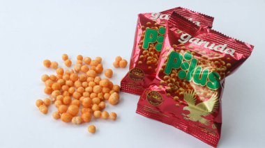 Semarang, Indonesia 23 Feb 2023 - Pilus Garuda branded spicy round snack isolated on a white background.