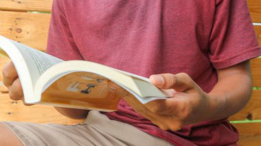 A man sitting and reading a book. Social life. literacy reading a book.