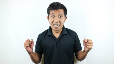 Outraged aggressive and pissed-off asian man shaking hands frustrated and mad, frowning and grimacing, swearing angry at someone, feeling furious, standing white background.