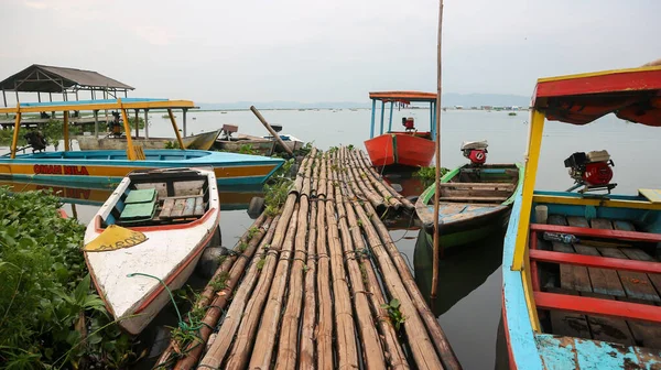 Semarang, 7 April 2023 - Fishing boats on the shores of Rawa Pening lake. Beautiful view of Rawa Pening lake and the Merbabu and Telomoyo mountains. Fishermen at Rawa Pening lake.