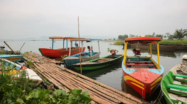 Semarang, 7 April 2023 - Fishing boats on the shores of Rawa Pening lake. Beautiful view of Rawa Pening lake and the Merbabu and Telomoyo mountains. Fishermen at Rawa Pening lake.