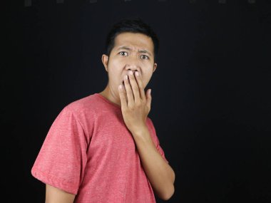 Oh hayır. Şaşırmış Asyalı adamın yakından çekilmiş portresi avuç içi küfle kaplanmış kameraya bakıyor, haberlere bakıyor, siyah arka planda tek başına duruyor.