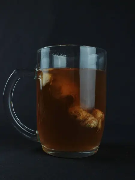 wedang jahe or ginger drink is traditional drink from Indonesia. Dark background
