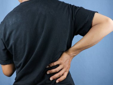 İnsanın elinin arkadan görünüşü, sırt ağrısına dokunuşu, bel ağrısı konsepti..