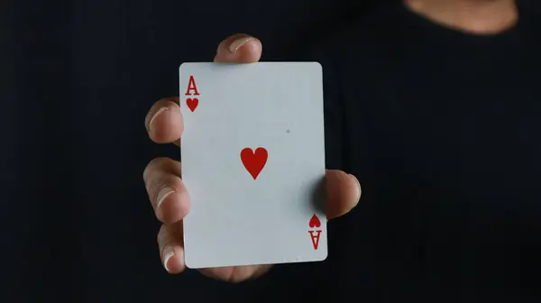 aces in hand, game with cards, dark background