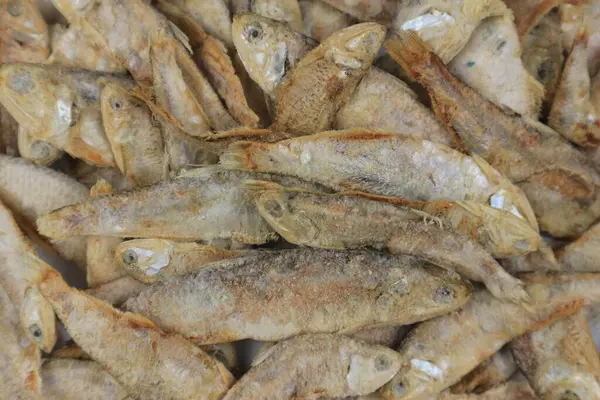 Top view of dried salted fish (ikan asin). Close-up of fish in a traditional market. Flat lay.