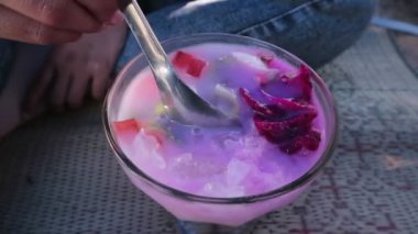 Bir bardak sop buah ya da meyve çorbası içen bir kadının elini kapat.