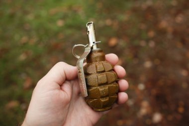 Russian (soviet) hand grenade F1 in man's hand clipart