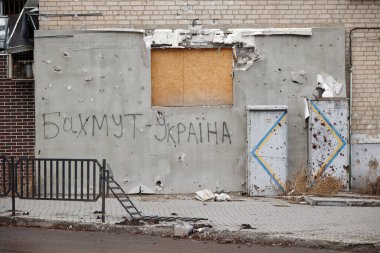Bakhmut, UKRAINE JAN 19 2023 The writing 'Bakhmut is Ukraine' on the wall of damaged by russian shelling building at Bakhmut during russian invasion to Ukraine