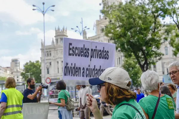 stock image Protesters in front of the Town Hall, Cibeles, during Green Tide, Marea Verde demonstration in Madrid, Spain, against the pillage of state public education money to support private schools.