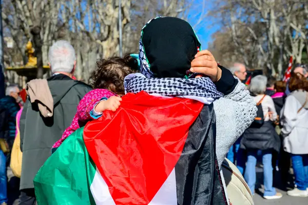 stock image Supporters and activists during the demonstration in support of the Palestinians and a free Palestine in the centre of Madrid Spain. Madrid Spain February 17th 2024