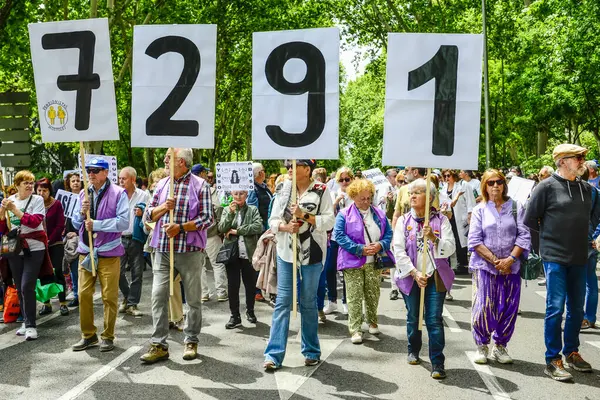 stock image Demonstrators showing the number of elderly death during covid marched from all corners of Madrid to the Town Hall in Cibeles, in support of a public healthcare service against the neglect and privatisation of the healthcare system in the region of M