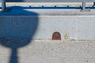 A close view of the front door of the house of Raton Perez, the Spanish tooth fairy, outside Metro Bank of Spain, in the bright afternoon sunlight in summer, Madrid Spain.