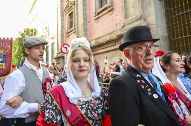 A young female chulapa in traditional dress of Madrid  and a male wearing a bowler hat and formal suit during the fiesta of San Cayetano, Madrid Spain clipart