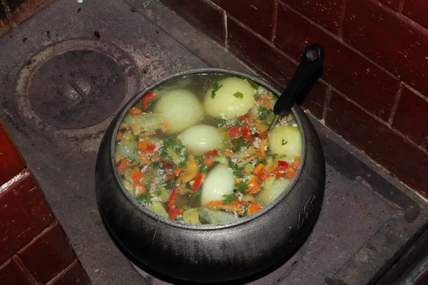 rustic fish soup in cast-iron pan, healthy food    
