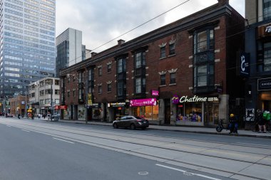 TORONTO, CANADA - Haziran 09, 2024: Yaz günü şehir merkezindeki yüksek binalar arasında modern şehir caddesi