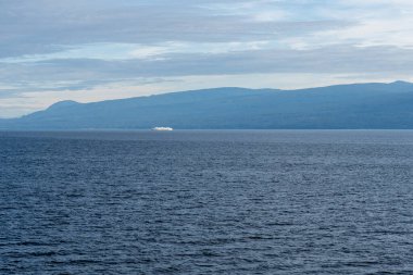 GEORJİA, CANADA 'NIN STRAIT - 29 Haziran 2024: Ufuktaki Britanya Kolumbiyası Kanada ufuktaki Gürcistan mavi gökyüzü su manzarası dağları üzerindeki bulutlar